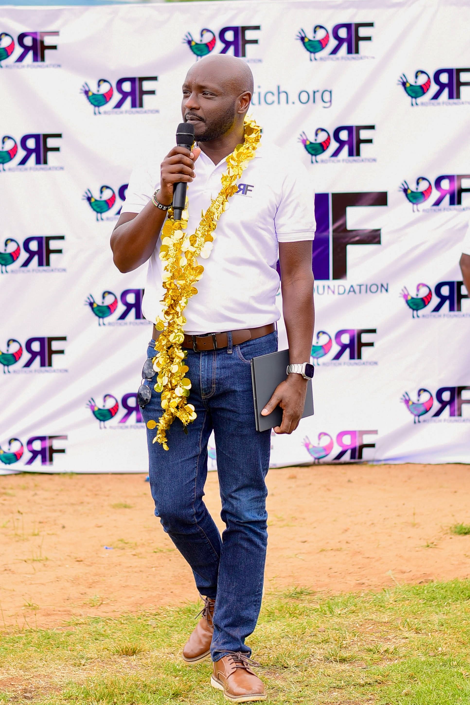 Peter Rotich speaking at a Rotich Foundation community event
