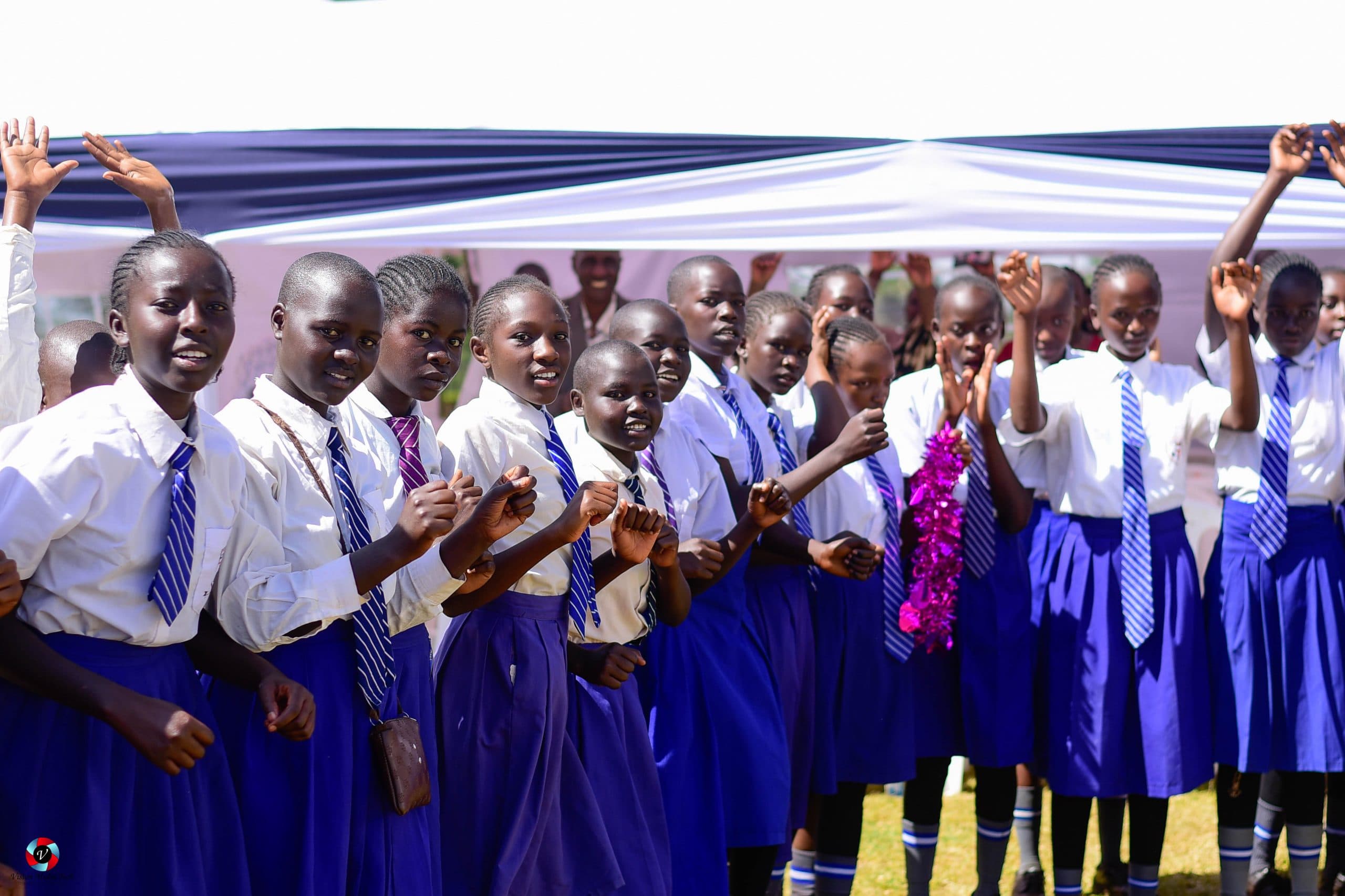 Students gathered outdoors in their school uniforms during a Rotich Foundation visit